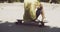 Man sitting on his longboard at a skate park
