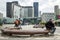 A man sitting on a marble bench having a call in Paris La Defense business district