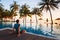 Man sitting near swimming pool and relaxing in luxury hotel