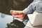 A man sitting near the water. Foots over the water. Relaxing concept