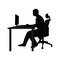 Man sitting on office chair at table and working