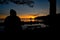 Man sitting overlooking sunset over lake Vattern