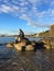 Man sitting on rocks on beach