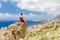 Man sitting on rocky ledge, Crete Island, Greece