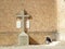 Man sitting on stairs, next to a cross, in Penas de San Pedro, Castilla La Mancha, Spain.