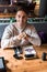 Man sitting in sushi bar near table with menu