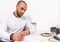 Man sitting thinking as he checks a written report