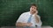 Man sitting and thinking in front of moving maths calculations on chalkboard 4k