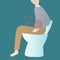 A man sitting on the toilet bowl and suffering from constipation.