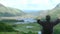 Man sitting on the top of a mountain enjoying the landscape