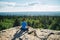 Man sitting on the top of the mountain in meditation session in Lotus Posture, padmasana, practicing pranayama