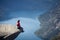 Man sitting on trolltunga rock in norway