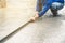 Man sitting and using a wooden spatula for cement after Pouring ready-mixed concrete.