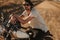 Man sitting on a vintage motorcycle outdoors