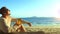 Man sitting in white dress drinks pineapple cocktail Pina Colada on beach. Concept rest sea, tropical resort traveling