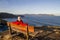 Man sitting on wooden bench in Loiba cliffs, Galicia, Spain