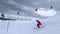 Man skier riding and jumping on springboard on mountain ski on snowy slope