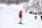 A man skier slides down the mountain over white snow in a sports tourist base Turquoise Katun. Seasonal sports