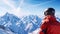 Man skier standing at the peak of snowy mountain, clear blue sky