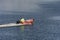 Man in skiff skimming across river