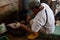 Man slaughts a freshly catch fish to sell to customers