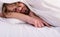 Man sleepy drowsy unshaven bearded face covered with blanket having rest. Guy lay under white bedclothes. Fresh