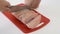 Man slices finely frozen meat