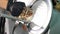 Man is slicing a piece of smoked meat with automatic slicer machine.