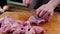 Man slicing pork meat on a table, working process closeup. Kitchen, knife.