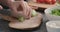 Man slicing ripe avocado on kitchen countertop