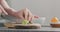 Man slicing ripe avocado on kitchen countertop side view