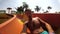 A man slides down a small water slide at a waterpark. Portrait of a man in aquapark