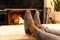 Man in slippers relaxing with his feet up with a fireplace in the background.