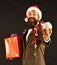 Man in smart suit, Santa hat and garlands on brown