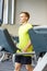 Man with smartphone exercising on treadmill in gym
