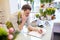 Man with smartphone making notes at flower shop