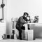 Man with smartphone sitting at table with teddy bear