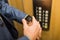 Man with smartwatch on his hand with elevator control panel in the background