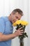 Man Smiling Holds and Smells Yellow Roses Bouquet