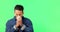 Man sneezing, blowing nose on green screen and sick with cold or flu, allergies and sinus problem with mockup space