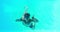 Man in snorkel jumping in swimming pool waving at camera