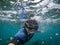 Man in snorkel mask doing selfie underwater. Vacation, freediving and travel concept.