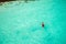 Man snorkeling in clean water over coral reef