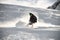 Man on a snowboard gliding on a snowy mountain