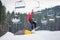 Man on the snowboard jumping over a hurdle