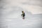 Man on a snowboard slipping on a snowy mountain