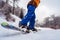 Man snowboarder is glides with snow splashes