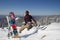 A man in snowboarding gear on the top of a mountain. Young man standing with a snowboard on the top of the mountains