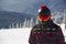 A man in snowboarding gear on the top of a mountain. Young man standing with a snowboard on the top of the mountains