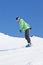 Man Snowboarding On Ski Holiday In Mountains